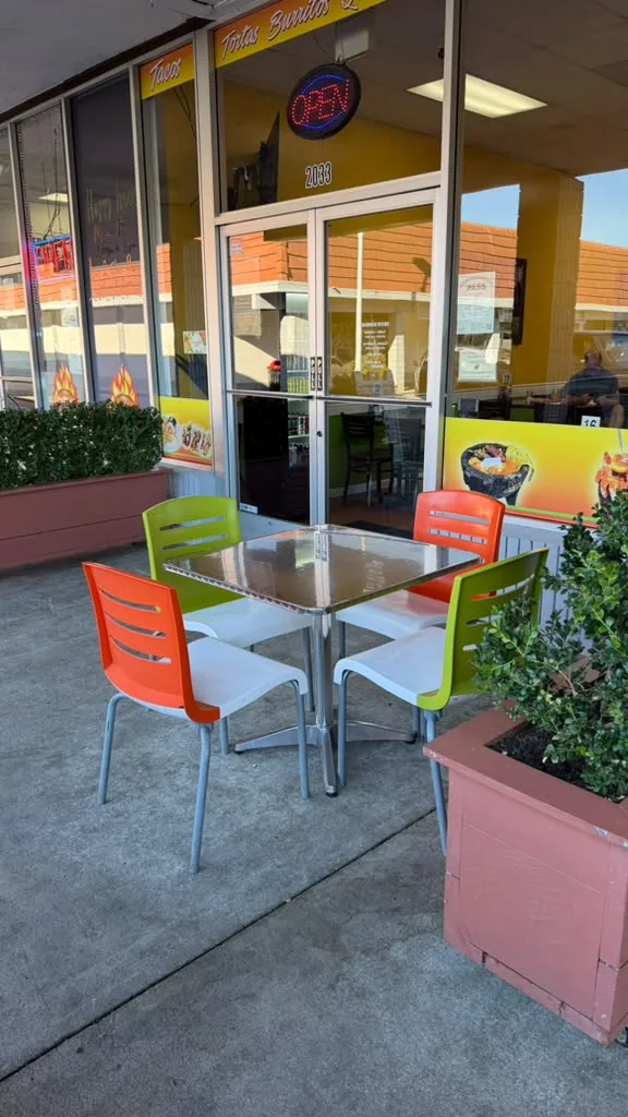 Patio table with orange and green chairs