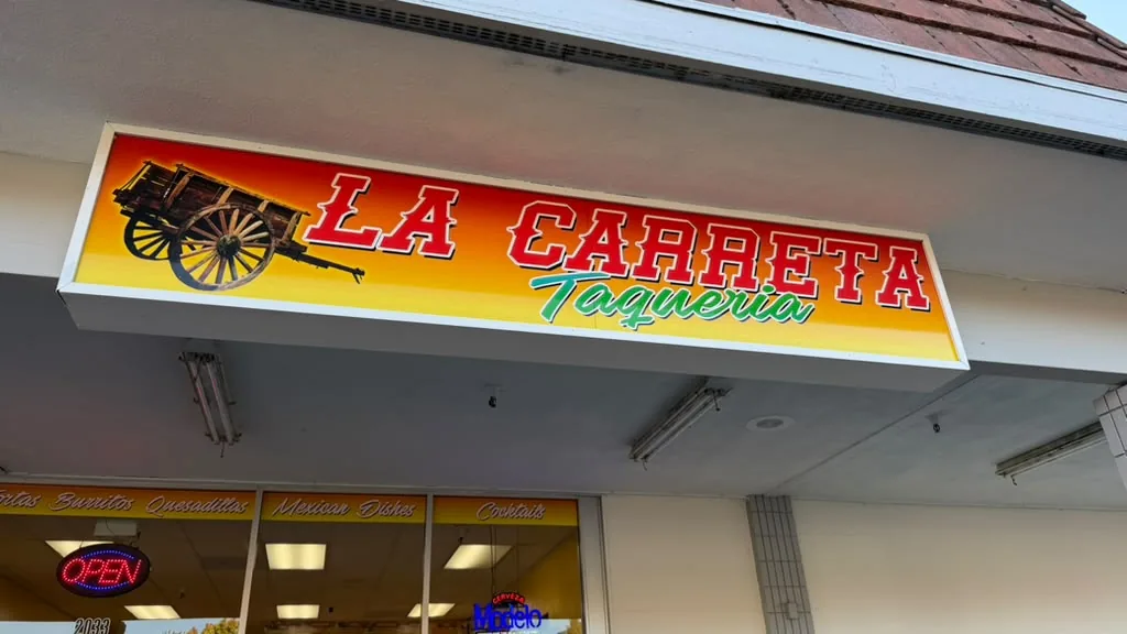 La Carreta Taquería sign with a wooden cart