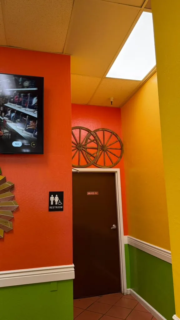 Wagon wheels on an orange wall
